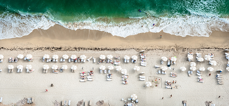 crowds sunbathing on the beach in miami