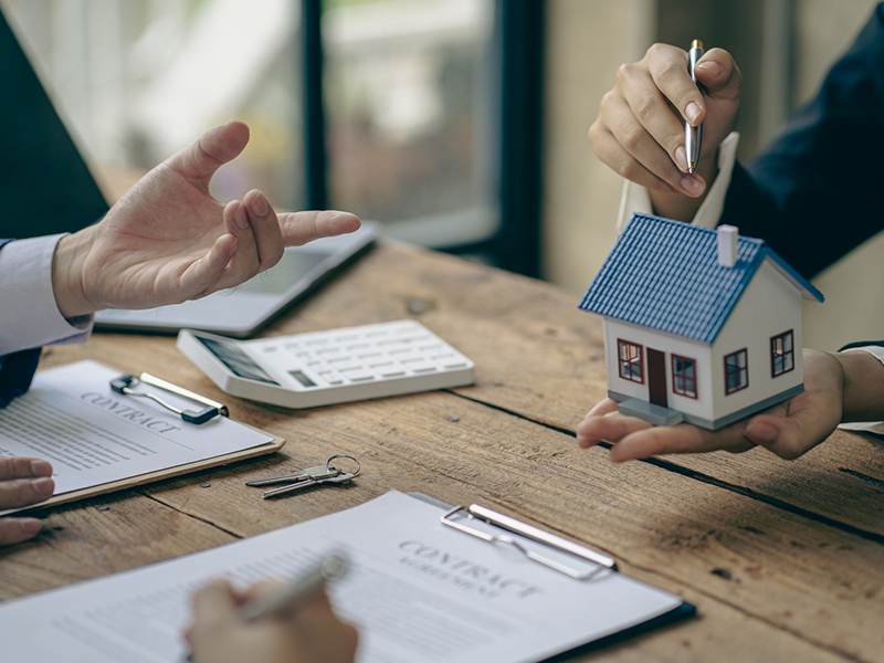 florida real estate agent holding a miniature house